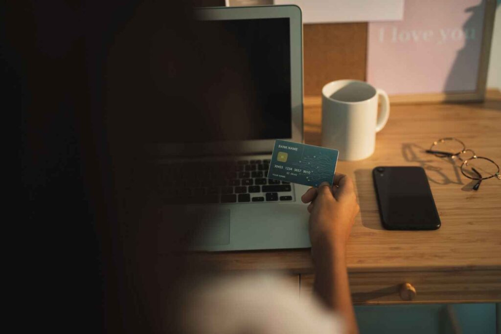 Concerned woman holding credit card symbolizing consumer risk after Target data breach.